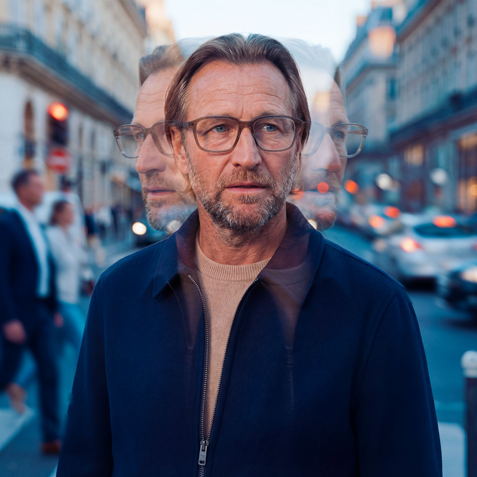 A person wearing conventional eyeglasses on a busy street with multi-exposure effects. 
