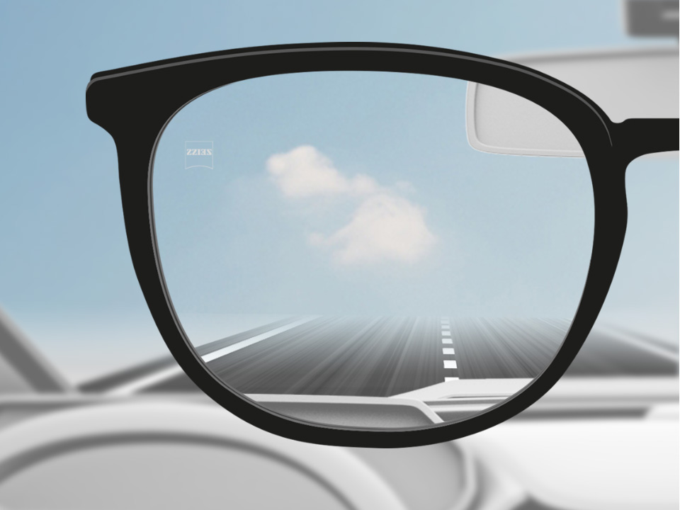 A point of view image of a car driver with ZEISS Single Vision DriveSafe lenses and the lens being fully clear. 