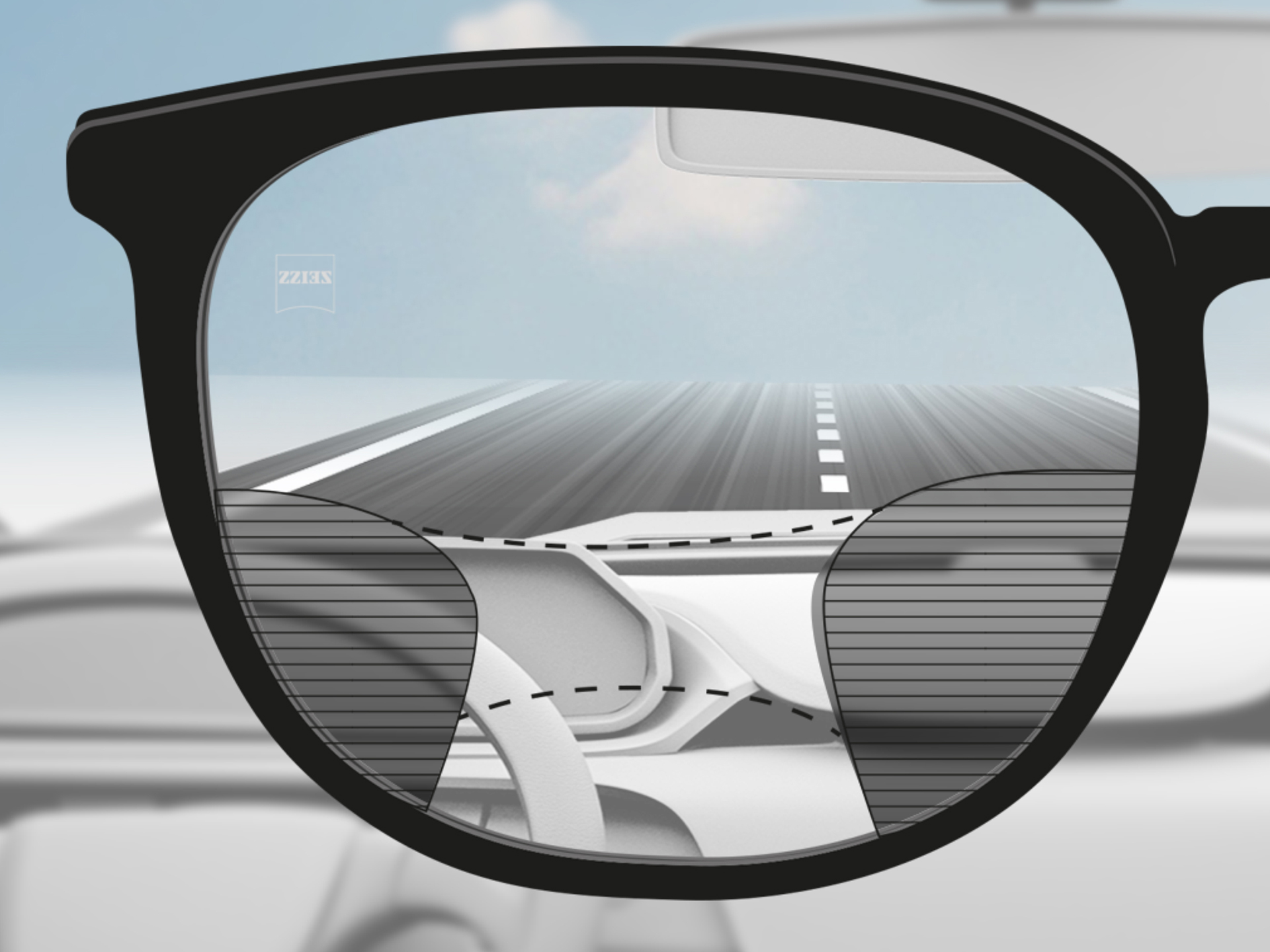 A point of view image through a ZEISS Progressive DriveSafe lens: The vision zones are adapted so the driver has clear vision zones on the road and dashboard.